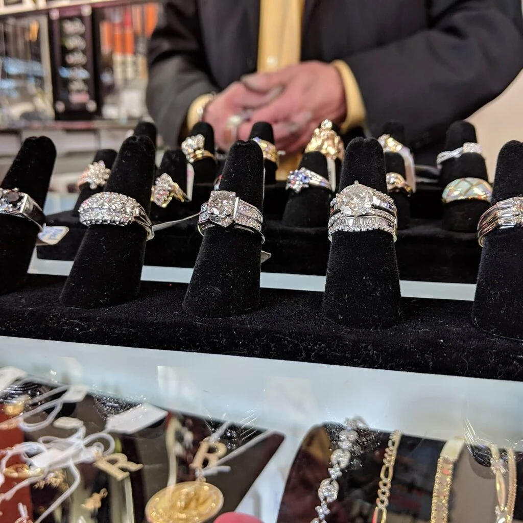 Diamond rings displayed on black velvet in a glass case